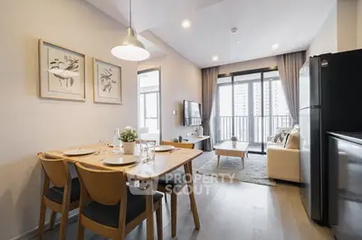 Modern open-plan living and dining area with stylish decor and large windows.