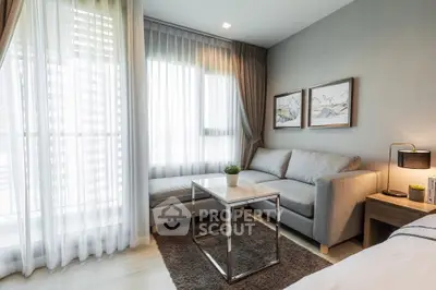 Modern living room with stylish sofa and natural light in a cozy apartment.