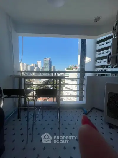 Chic urban balcony with stunning cityscape view, perfect for relaxation and enjoying the skyline.