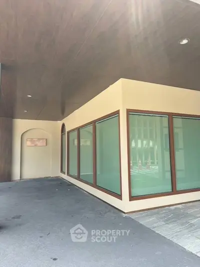 Modern building exterior with large glass windows and wooden accents