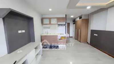 Modern open-plan kitchen with sleek cabinetry and ample storage space.