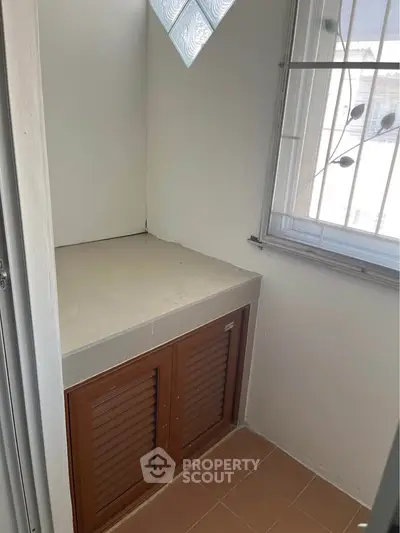 Compact storage area with natural light and secure window bars