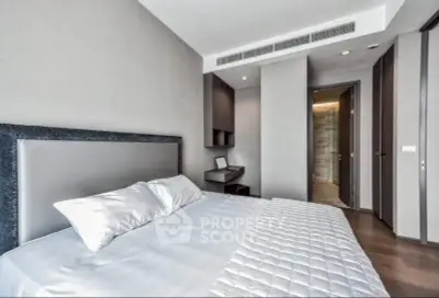 Modern bedroom with sleek design and neutral tones, featuring a comfortable bed and stylish decor.