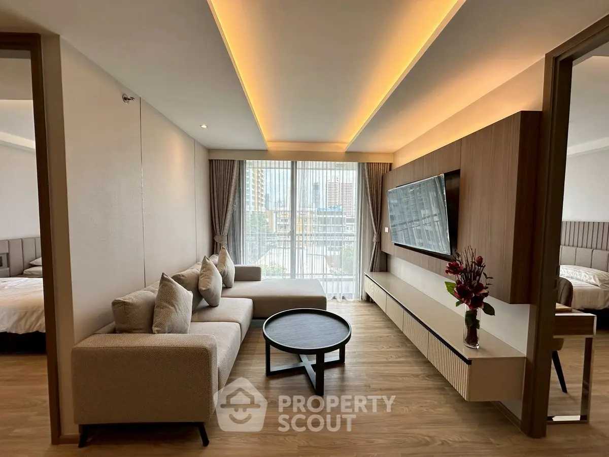 Modern living room with elegant decor and large windows offering city views