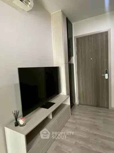 Modern apartment entrance with sleek TV stand and stylish decor