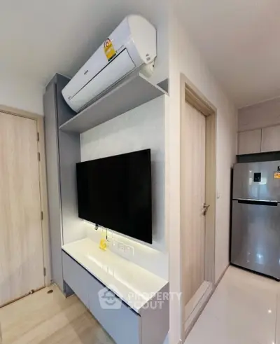 Modern apartment interior with sleek TV unit and air conditioning