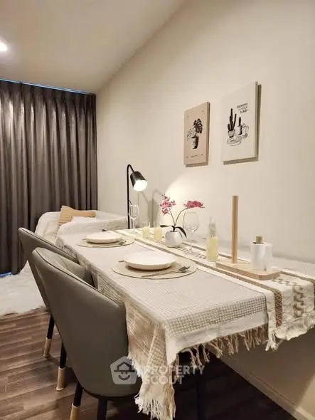 Cozy dining area with elegant table setting and modern decor in a stylish apartment.
