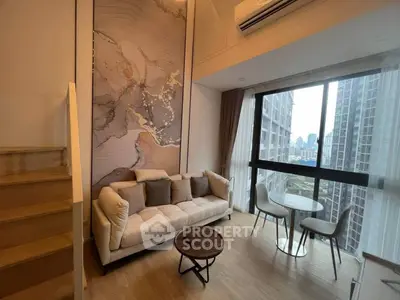 Modern living room with large window and city view, featuring stylish furniture and elegant decor.