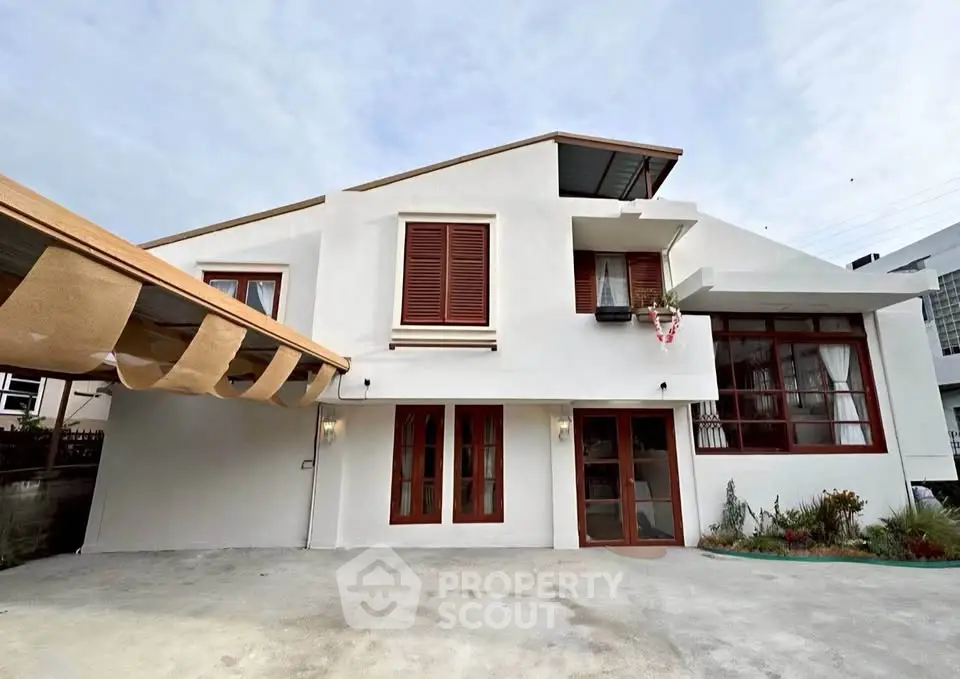 Modern two-story house with unique architectural design and spacious driveway