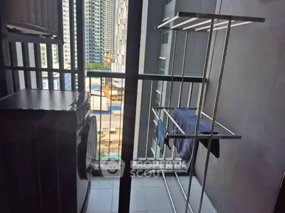 Modern balcony with laundry area and city view in high-rise apartment