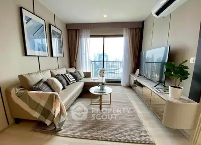 Modern living room with stylish decor and city view, featuring a comfortable sofa and large TV.