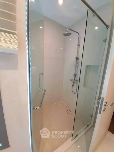 Modern bathroom with glass shower enclosure and sleek fixtures