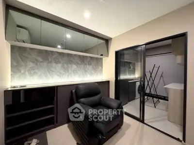 Modern living room with sleek design and adjacent laundry area