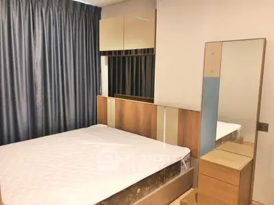 Modern bedroom with stylish wooden furniture and large mirror