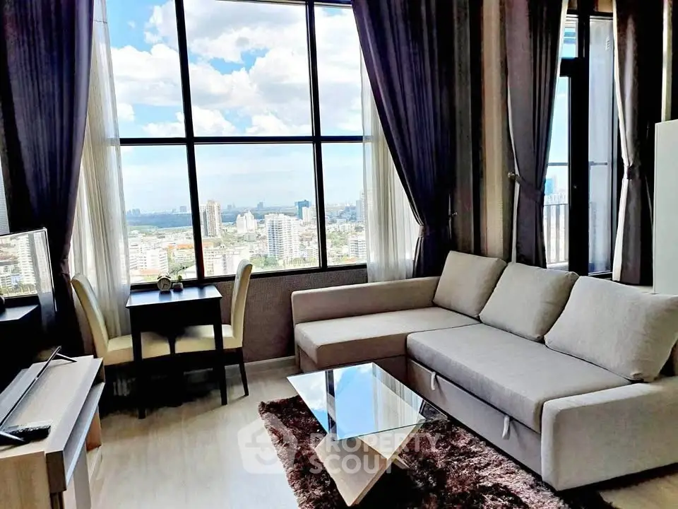 Stunning high-rise living room with panoramic city views and modern furnishings.