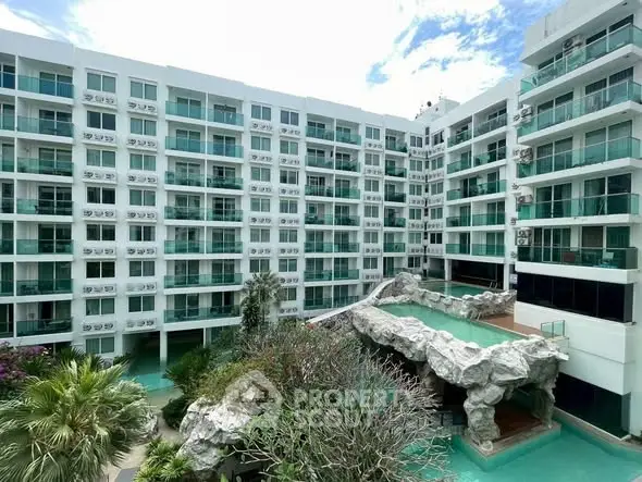 Modern apartment building with unique pool and lush greenery