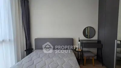 Modern bedroom with stylish furniture and natural light, perfect for relaxation and comfort.