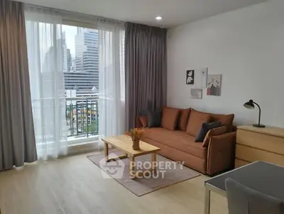 Modern living room with city view, featuring cozy sofa and stylish decor.