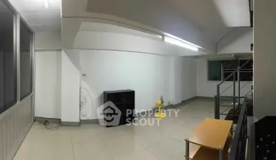 Spacious interior with modern design and ample natural light, featuring minimalist furniture and sleek flooring.