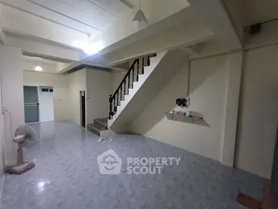 Spacious interior with staircase and tiled flooring, ideal for modern living.