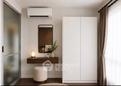Modern bedroom with sleek wardrobe and stylish vanity area
