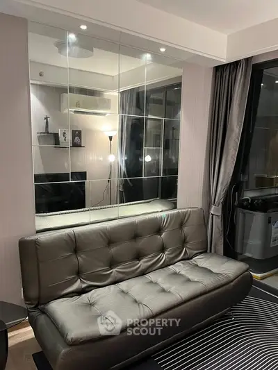 Modern living room with sleek leather sofa and mirrored wall accents