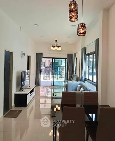 Spacious modern living room with elegant lighting and large windows for natural light.