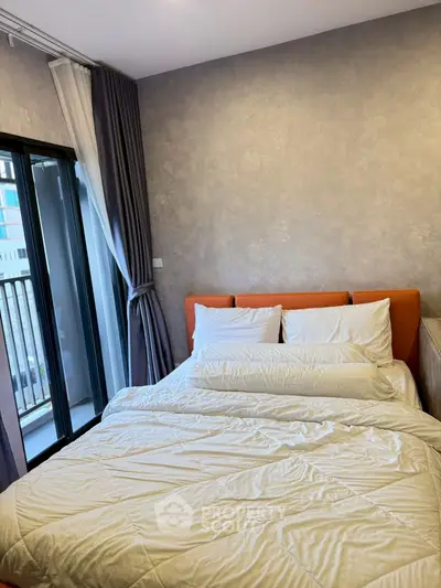 Cozy bedroom with modern decor and balcony access