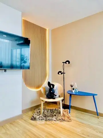 Stylish modern living room with unique lighting and cozy seating area.