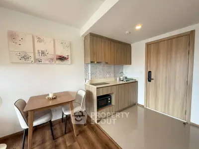 Modern compact kitchen with wooden cabinets and dining area in stylish apartment