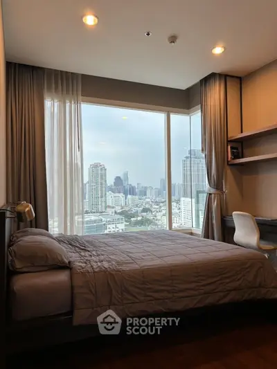 Modern bedroom with stunning city view and cozy decor