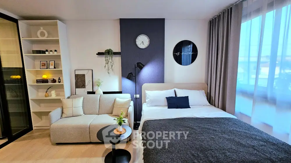Modern studio apartment with cozy living area and stylish decor