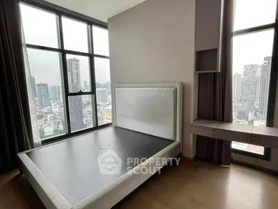 Modern bedroom with stunning city view and large windows