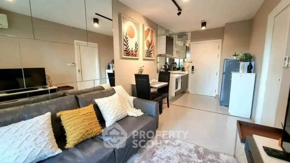 Modern living room with stylish decor and open kitchen layout in a cozy apartment.
