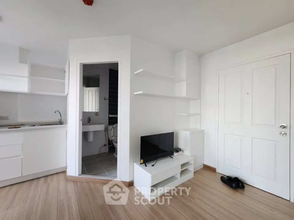 Modern minimalist apartment interior with open kitchen and cozy living area