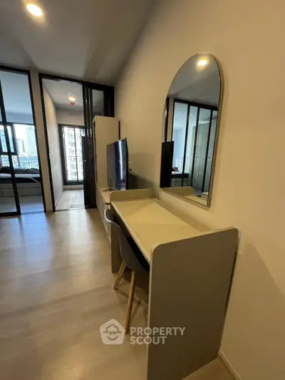 Modern apartment interior with sleek furniture and large mirror