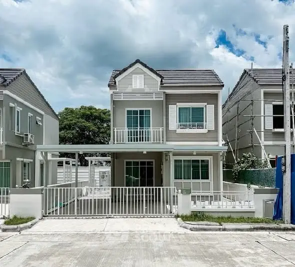 Charming two-story house with modern design and spacious front yard in a serene neighborhood.