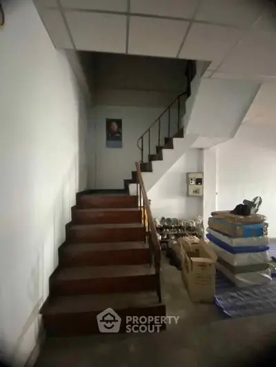 Spacious interior with staircase and storage area, ideal for creative renovation opportunities.