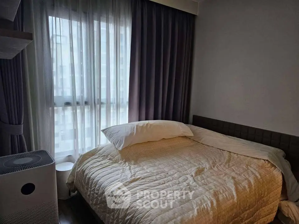 Cozy bedroom with soft lighting and modern decor, featuring a comfortable bed and stylish curtains.