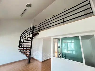 Modern loft apartment with spiral staircase and large windows