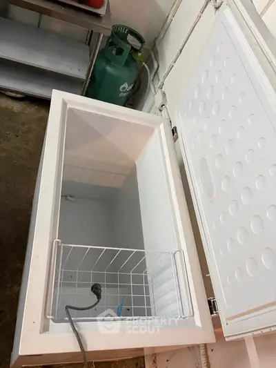 Spacious white chest freezer in a utility room, perfect for extra storage needs.