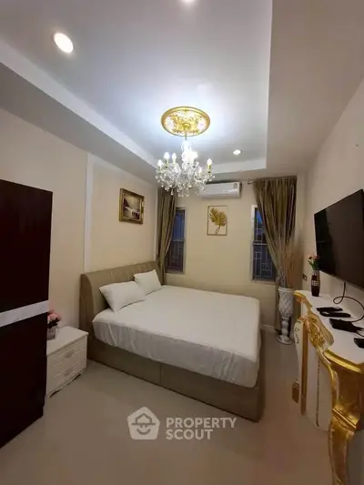 Luxurious bedroom with elegant chandelier and modern decor