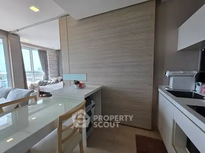 Modern open-layout kitchen with dining area and bright living room view.
