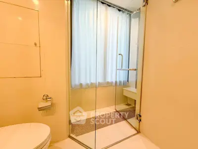 Modern bathroom with glass shower and natural light