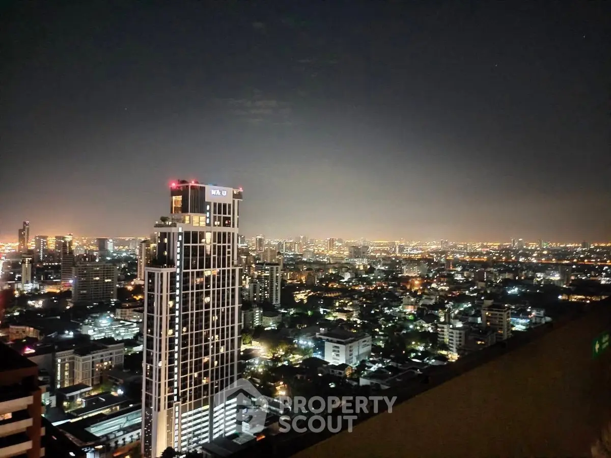 Stunning cityscape view from high-rise building at night, showcasing vibrant urban lights and skyline.