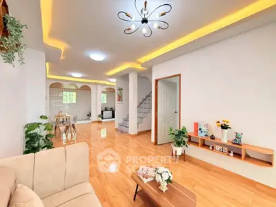 Spacious open-plan living room with modern lighting and elegant decor