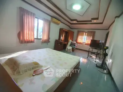 Spacious bedroom with natural light and modern decor