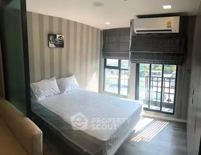 Modern bedroom with balcony and air conditioning in a stylish apartment
