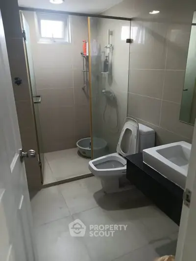 Modern bathroom with glass shower and sleek fixtures