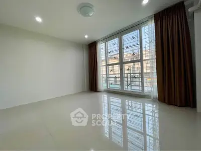 Spacious empty room with large windows and glossy floor tiles